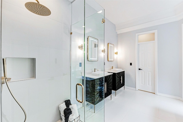 full bath featuring a shower stall, vanity, crown molding, and baseboards