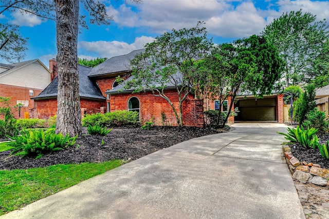 view of front of home featuring brick siding, driveway, roof with shingles, and an attached garage
