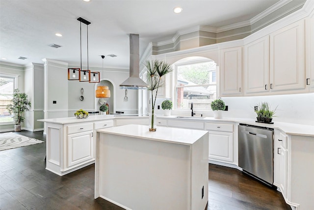 kitchen featuring dishwasher, range hood, a center island, arched walkways, and plenty of natural light