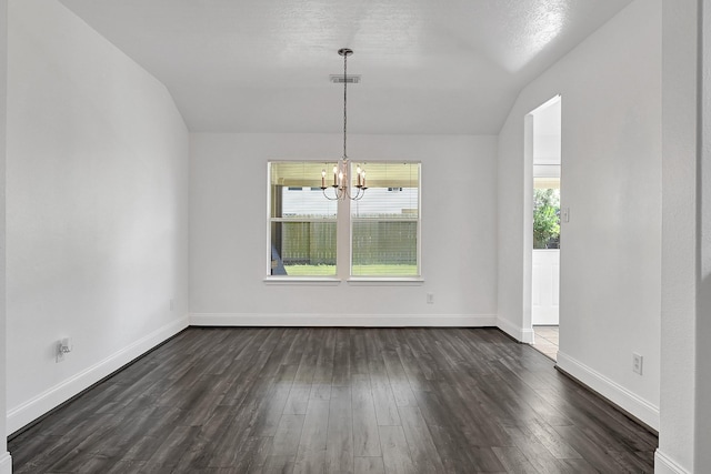 unfurnished dining area featuring dark wood finished floors, vaulted ceiling, visible vents, baseboards, and a notable chandelier