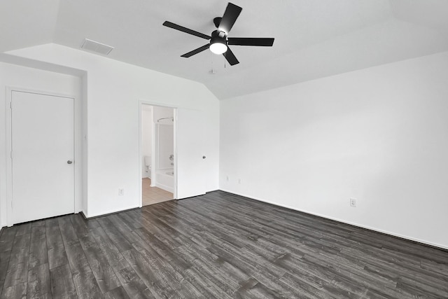 unfurnished bedroom with lofted ceiling, dark wood-style floors, visible vents, a ceiling fan, and ensuite bathroom