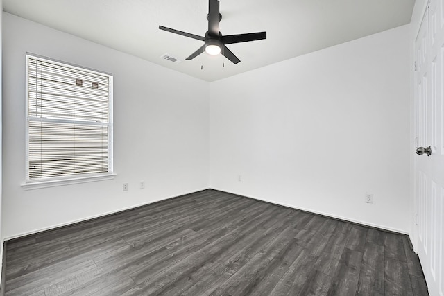 unfurnished room featuring a ceiling fan, visible vents, dark wood-type flooring, and a healthy amount of sunlight