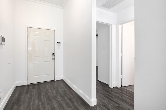 foyer entrance featuring dark wood finished floors, visible vents, baseboards, and ornamental molding