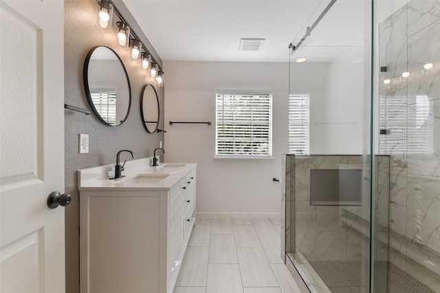 bathroom with visible vents, a sink, a shower stall, and double vanity