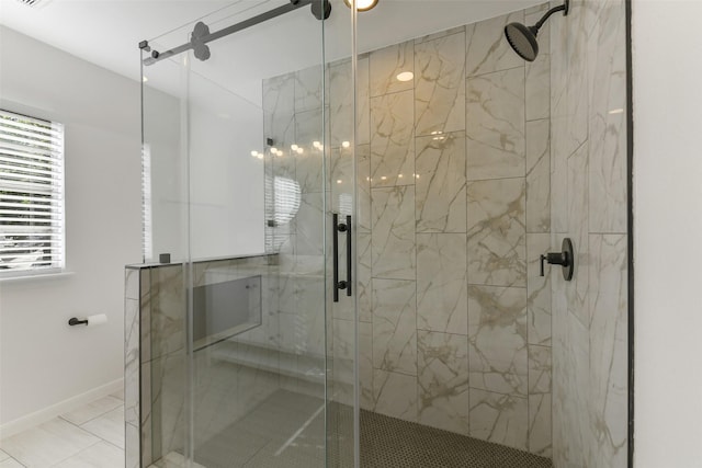bathroom with baseboards and a shower stall