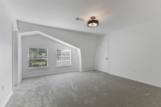 bonus room featuring vaulted ceiling, carpet, visible vents, and baseboards