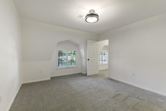interior space featuring visible vents, baseboards, and carpet flooring