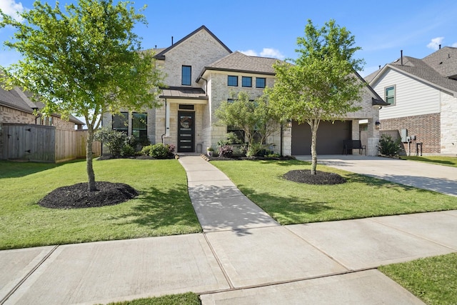 view of front facade with concrete driveway, fence, a front yard, metal roof, and a standing seam roof