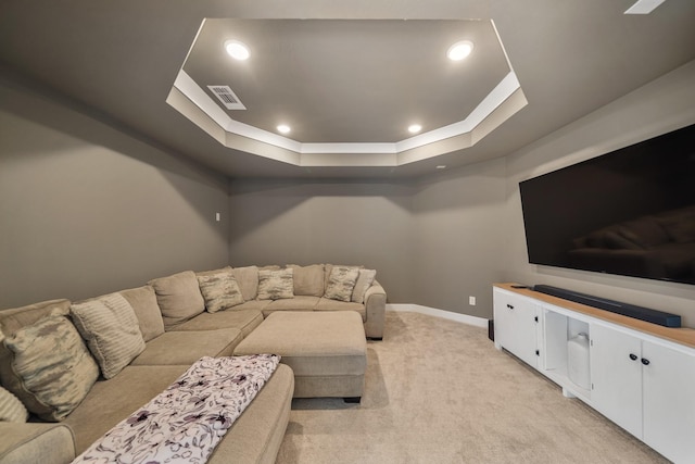 living room featuring light carpet, a tray ceiling, baseboards, visible vents, and recessed lighting