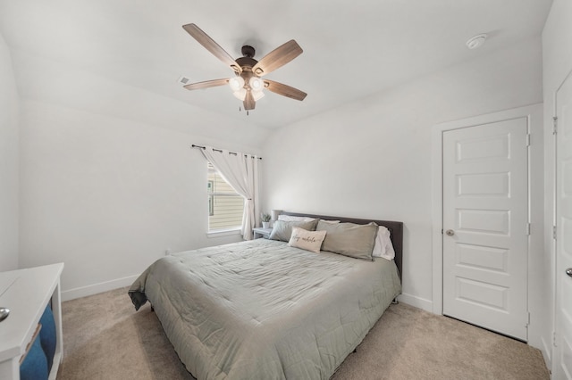 bedroom featuring ceiling fan, baseboards, and light carpet