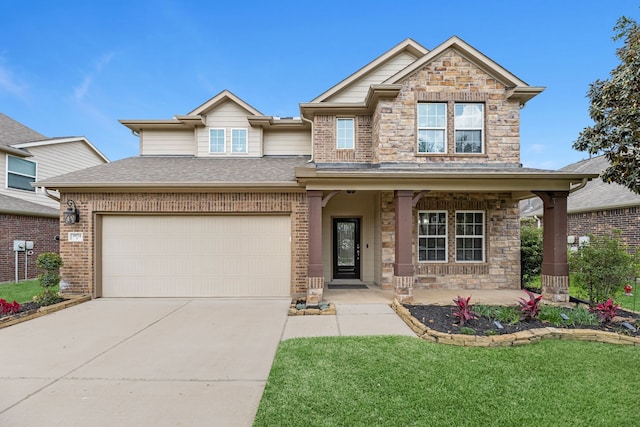 9974 Stone Creek Ln, Brookshire, TX 77423 - view of front facade with a porch, concrete driveway, an attached garage, stone siding, and brick siding