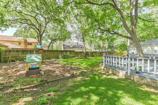view of yard featuring a fenced backyard and a deck
