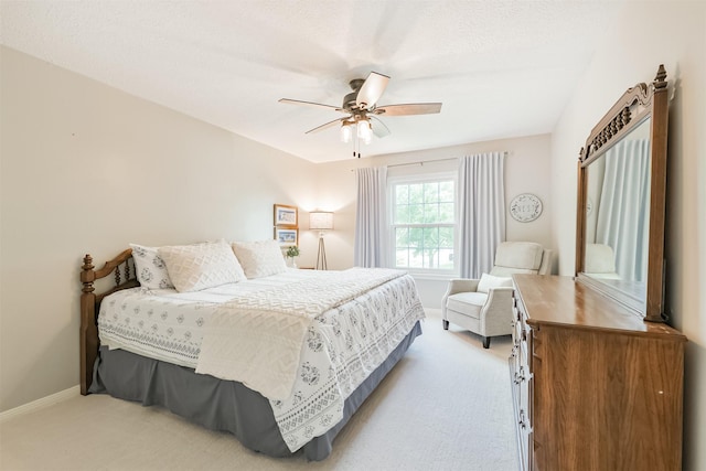bedroom with ceiling fan, baseboards, and light colored carpet