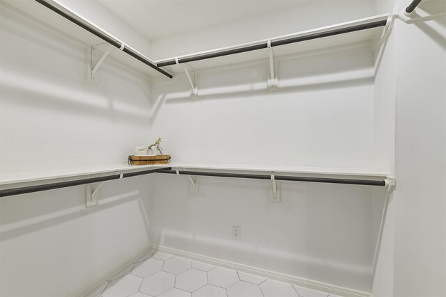 spacious closet featuring light tile patterned floors
