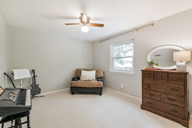 sitting room with ceiling fan, baseboards, and carpet flooring