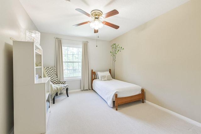 bedroom featuring ceiling fan, baseboards, and carpet