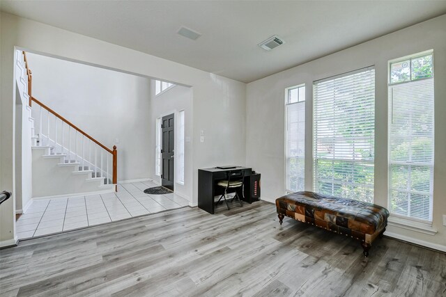 entrance foyer with wood finished floors, stairs, and baseboards