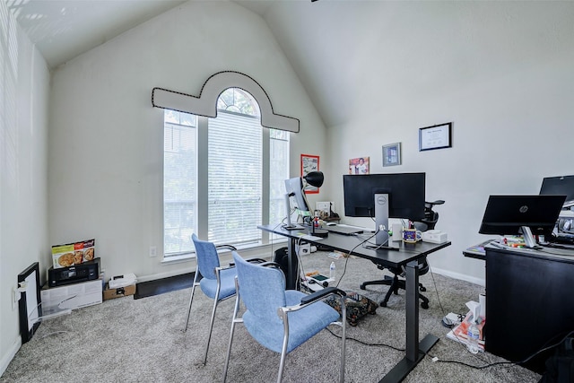 office area with healthy amount of natural light, carpet, high vaulted ceiling, and baseboards