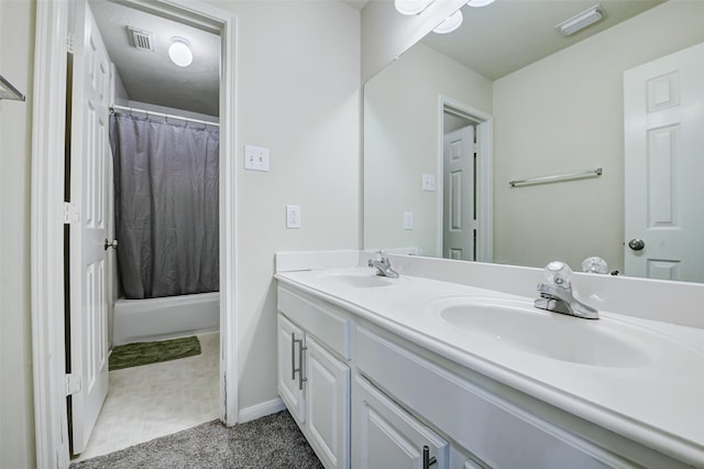 full bathroom with double vanity and baseboards