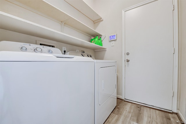 washroom with independent washer and dryer and light wood-style floors