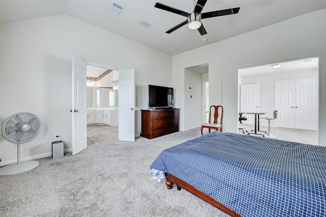 carpeted bedroom with lofted ceiling, baseboards, a ceiling fan, and ensuite bath