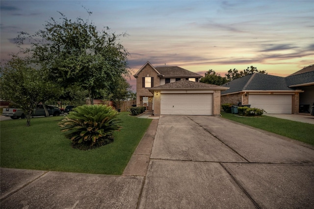 traditional-style house featuring brick siding, fence, an attached garage, concrete driveway, and a front lawn