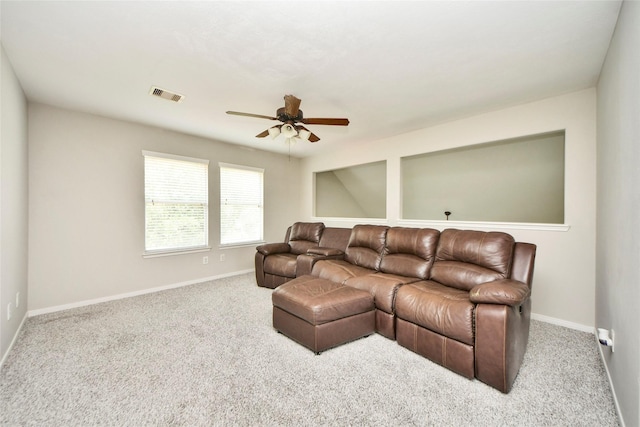 carpeted living area featuring baseboards, a ceiling fan, and visible vents