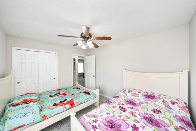 bedroom with a ceiling fan, carpet flooring, a closet, and baseboards