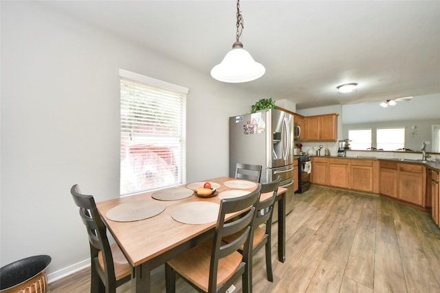 dining area featuring light wood-style flooring