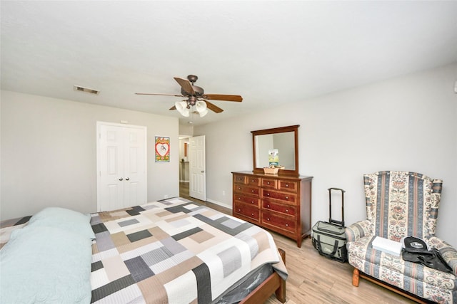 bedroom with a ceiling fan, a closet, light wood-type flooring, and visible vents
