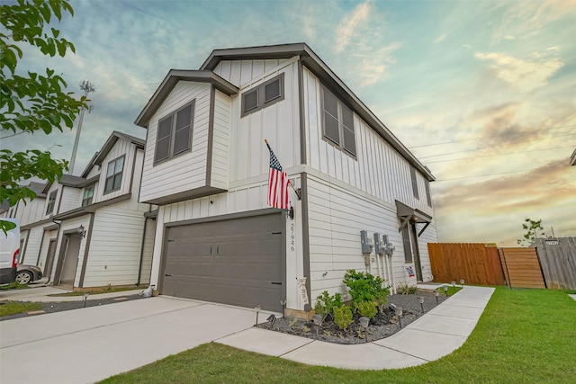 27946 Western Creek Ct, Katy, TX 77494 - view of side of home with concrete driveway, fence, an attached garage, a lawn, and board and batten siding