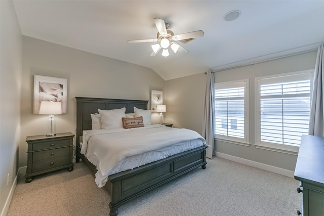 bedroom with a ceiling fan, baseboards, light carpet, and lofted ceiling