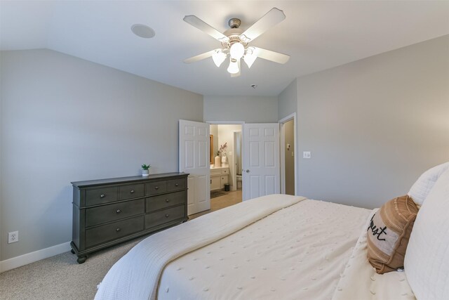 bedroom with a ceiling fan, baseboards, light colored carpet, and vaulted ceiling