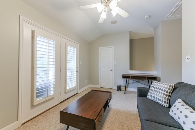 living room with carpet flooring, attic access, a ceiling fan, baseboards, and vaulted ceiling
