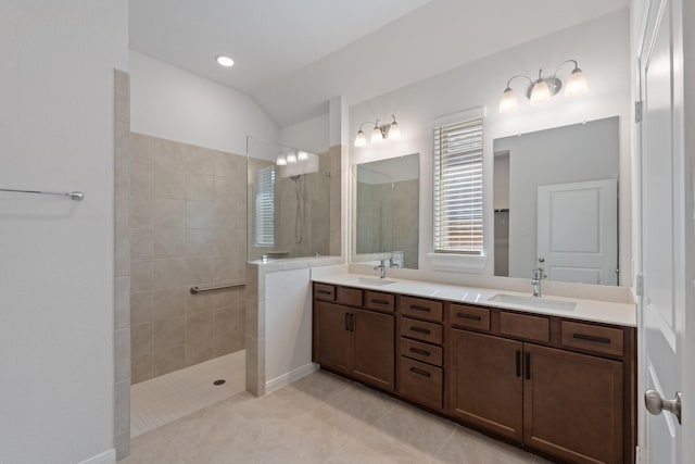 full bathroom featuring tile patterned floors, a sink, a walk in shower, and double vanity