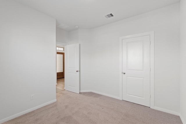 unfurnished bedroom featuring carpet floors, visible vents, and baseboards