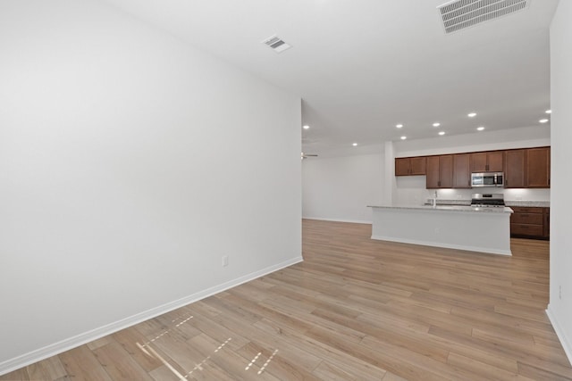 unfurnished living room featuring light wood finished floors, visible vents, and recessed lighting