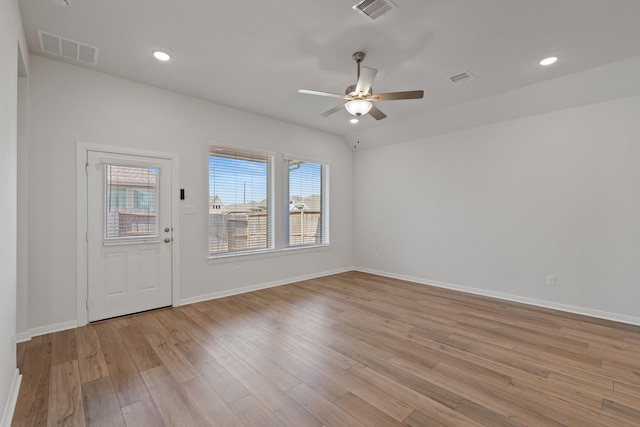 interior space with light wood finished floors, visible vents, and ceiling fan