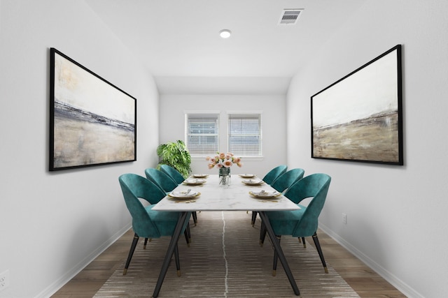 dining space with baseboards, wood finished floors, and visible vents