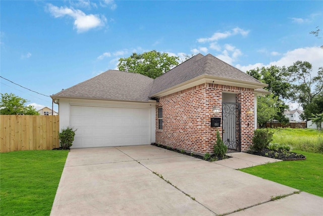 view of front of property with brick siding, fence, a front lawn, concrete driveway, and an attached garage