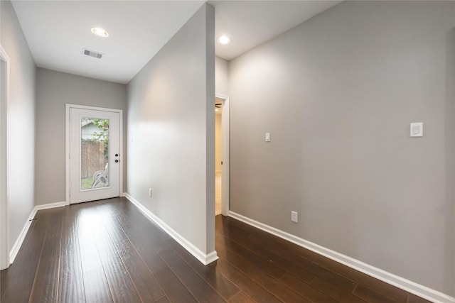 doorway to outside with visible vents, recessed lighting, baseboards, and dark wood finished floors