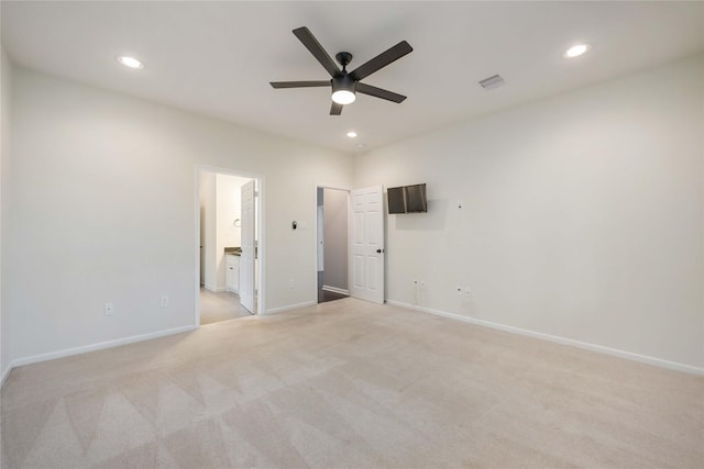 unfurnished bedroom with recessed lighting, light colored carpet, visible vents, and baseboards