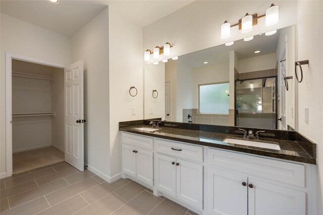 4901 Higgins St, Houston, TX 77033 - full bath with a stall shower, double vanity, tile patterned floors, and baseboards