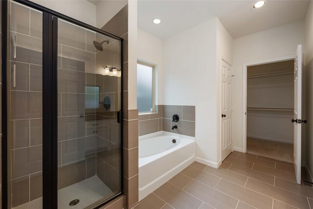 4901 Higgins St, Houston, TX 77033 - bathroom with a stall shower, a bath, tile patterned flooring, recessed lighting, and baseboards