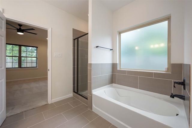 bathroom featuring tile patterned flooring, a shower stall, a ceiling fan, and a garden tub