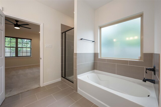 4901 Higgins St, Houston, TX 77033 - full bath with a ceiling fan, a stall shower, a bath, and tile patterned floors