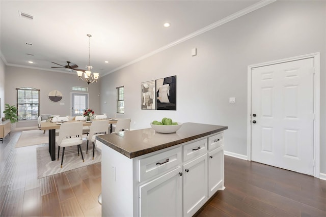 4901 Higgins St, Houston, TX 77033 - kitchen with dark countertops, recessed lighting, ornamental molding, open floor plan, and a center island