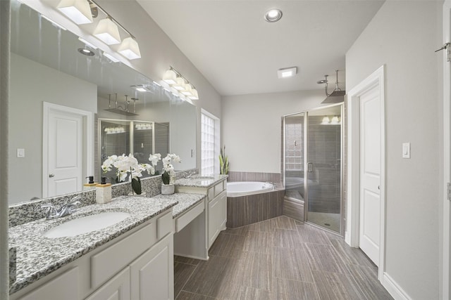 bathroom featuring a bath, vanity, and a shower stall