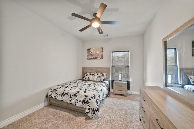 bedroom with light carpet, baseboards, visible vents, and ceiling fan