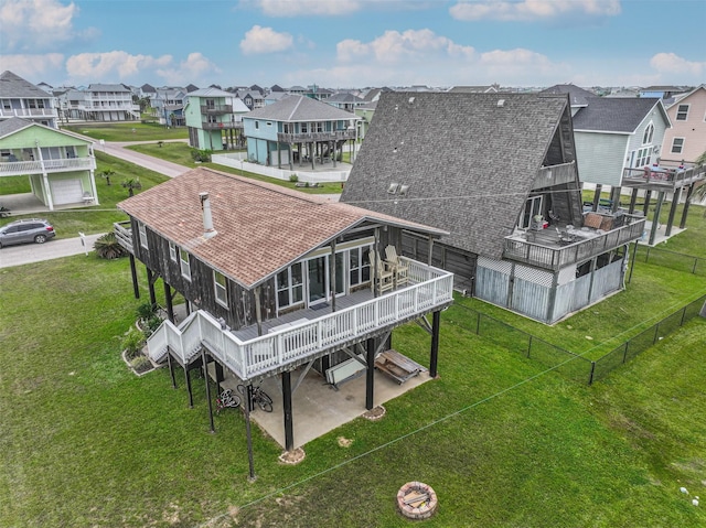 23001 Fresca St, Galveston, TX 77554 - rear view of house with a shingled roof, a residential view, a deck, and a patio area